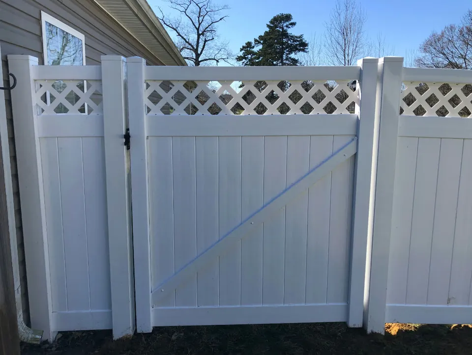 White vinyl lattice top privacy gate.